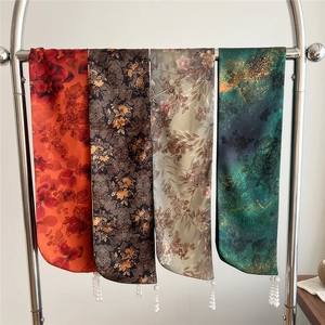 Vertical display of four floral satin scarves with elegant pearl tassel pendants