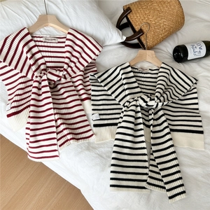 Striped knitted shawl for women featuring red and black patterns with decorative ties