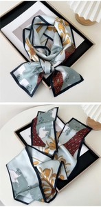 Detail of color-blocked floral silk scarf with premium satin texture and hemmed edges