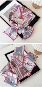 Detail of vintage horse print silk scarf showing retro pattern and smooth texture
