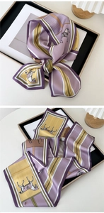 Close-up of a silk scarf with vintage horse prints and bold purple and yellow stripes