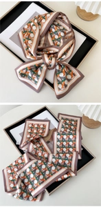 Detailed view of woven geometric pattern silk scarf with elegant grey-purple border
