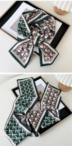 Detail of a 147cm narrow silk scarf with geometric patterns and washing label