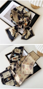 Detail of printed silk scarf with equestrian horse motifs and letter H pattern design