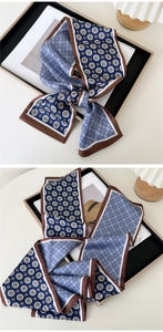 Detail of vintage geometric pattern silk-like long scarf in navy and brown tones