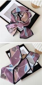 Detail of silk scarf with geometric patchwork, rose floral print and black border accents