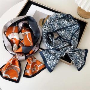 Elegant silk twilly scarf set featuring orange equestrian motifs and navy baroque floral patterns