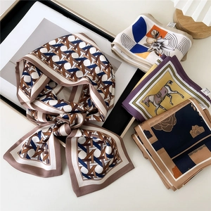 Elegant satin scarves featuring various equestrian and floral prints on a neutral background