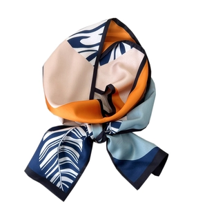 Elegant slim silk scarf with color-block leaf patterns on a white background