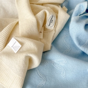 Detaillierte Makroansicht der Strickstruktur und Materialetiketten aus Wollmischung