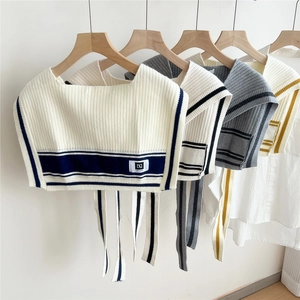 Knitted striped shawl with decorative bow and DG label in multiple neutral colors