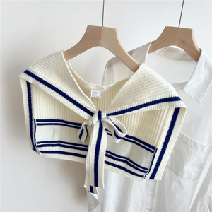 Detail of knitted shoulder wrap with navy stripes and 3% Australian wool material label