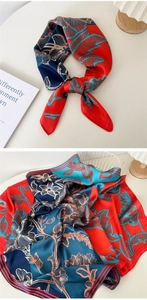 Detailed view of floral silk scarf featuring elegant red and blue patterns on satin fabric