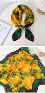 Detail of silk square scarf with yellow floral print and elegant dark brown border