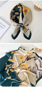 Detail of silk scarf with plum blossom pattern in green and beige vintage style