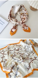 Detail of silk-feel square scarf with orange borders and magnolia floral print