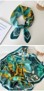 Macro shot of satin silk floral square scarf showing blue and yellow printed patterns