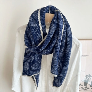 Gros plan de l'écharpe plissée bleu marine à motif paisley et bordure ondulée