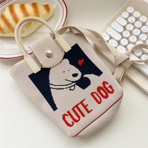 Close-up of cute polar bear knit crossbody bag with top handle and metal snap button