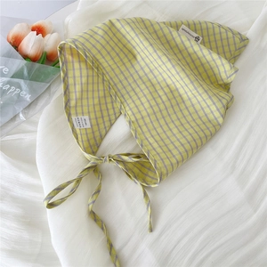 Detail of yellow and purple plaid cotton triangle scarf with 100% cotton label