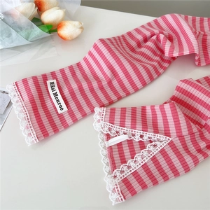 Pink and white striped knit sun protection sleeves with delicate lace trim detail