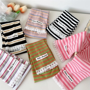 Striped knit arm sleeves with lace trim and brand label on white background