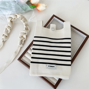 Striped knit phone crossbody bag with cream and black patterns and braided strap