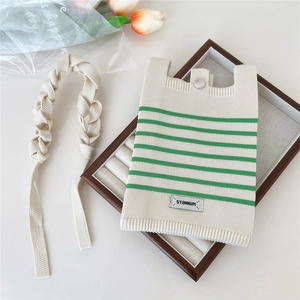 Striped knit phone crossbody bag with STANNUM label and green stripes on beige texture