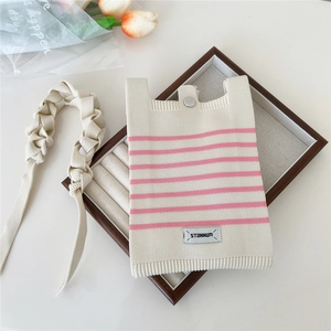 Close-up of cream knitted phone bag with pink stripes and silver snap button