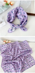Detail of purple floral cotton scarf showing 100% cotton tag and delicate flower patterns