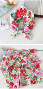 Detail of floral cotton square scarf showing red flower prints and soft fabric texture