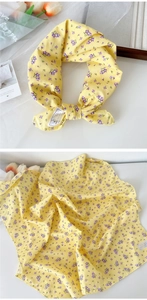 Detail of yellow cotton square scarf with purple floral pattern and fine stitching