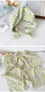 Detail of floral cotton square scarf with yellow and purple patterns and 100% cotton label