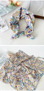 Detail of floral linen silk scarf showing delicate patterns and refined hemmed edges
