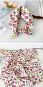 Detail view of floral print cotton scarf with soft texture and vibrant floral pattern