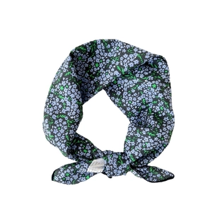 Floral cotton linen square scarf with small blue flowers and knotted design on white backdrop
