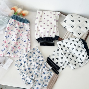 Flat lay of multiple floral print satin lounge pants with elastic waistbands