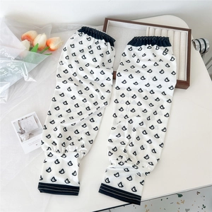Detail of white sun protection ice silk sleeves with black butterfly print and ribbed cuffs