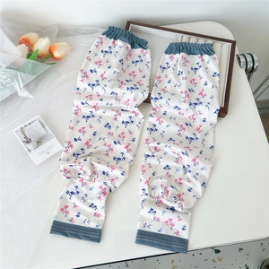 Detailed view of floral pattern cooling sleeves with elastic cuffs on a white desk