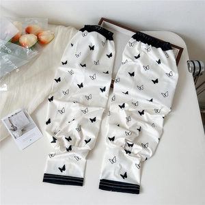 Detail of arm sleeves featuring vintage black butterfly prints and elastic cuffs