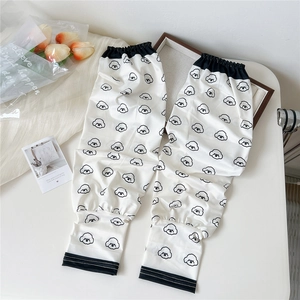 Detail of white sun protection sleeves with cartoon dog print and elastic cuffs