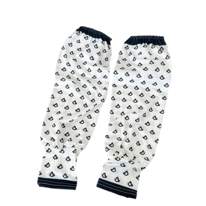 Minimalist sun protection cooling arm sleeves with black butterfly heart print on white fabric