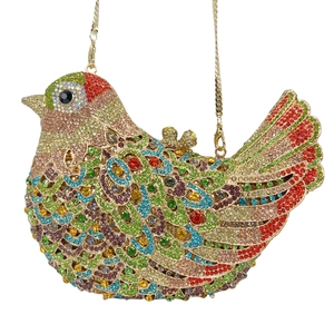 Detailed view of pigeon clutch bag with colorful rhinestones and gold metal chain