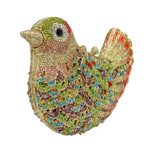 Macro detail of bird-shaped clutch showing colorful rhinestones and intricate feathers