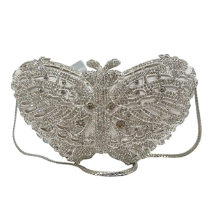Detail of silver butterfly evening clutch bag with sparkling rhinestones and metal chain
