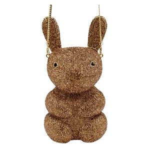 Macro detail of gold rabbit evening bag featuring brown crystals and fine chain