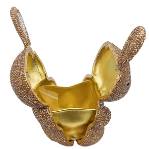 Detail of champagne gold rabbit evening bag showing interior compartment and rhinestone finish