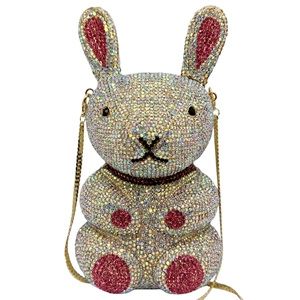 Macro shot of sparkling rabbit-shaped clutch with multicolored rhinestones and gold chain