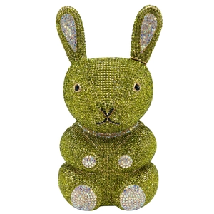 Detail of a rabbit-shaped evening clutch bag adorned with vibrant green and white crystals