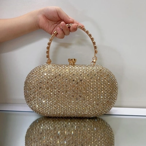 Elegant gold clutch evening bag with sparkling rhinestones and metal top handle